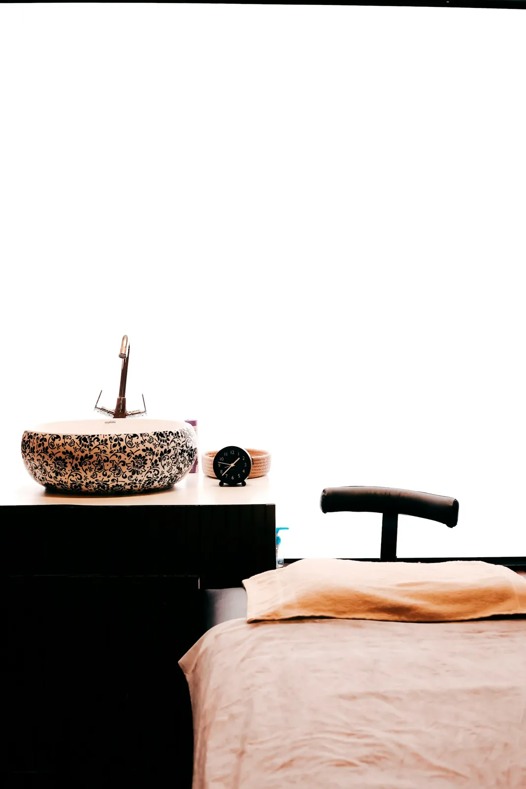A patterned basin beside a treatment bed.